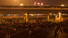 Guangzhou Railway Station illuminated in the dark with stranded passengers impatiently waiting for trains to go home.