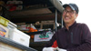Uncle Joe smiles in front of truck.